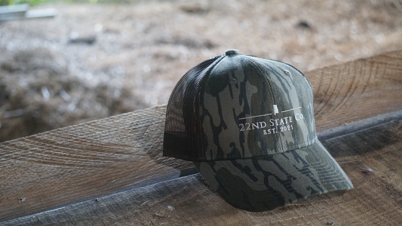 "22nd State Logo Hat" -Low Profile Trucker Cap (Mossy Oak Bottomland)
