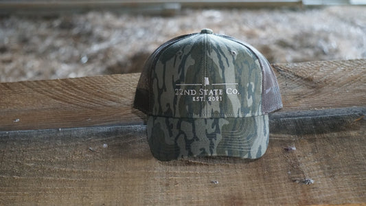 "22nd State Logo Hat" -Low Profile Trucker Cap (Mossy Oak Bottomland)